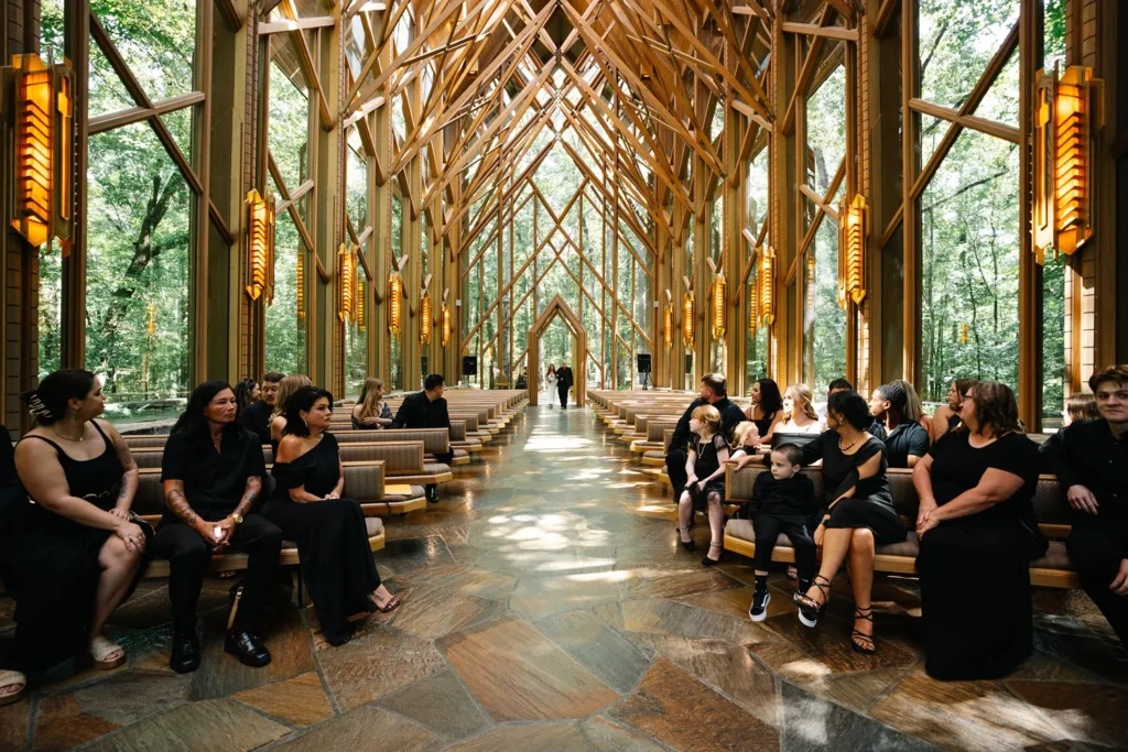 Guests seated inside Anthony Chapel during a wedding ceremony at Garvan Woodland Gardens in Hot Springs, Arkansas.