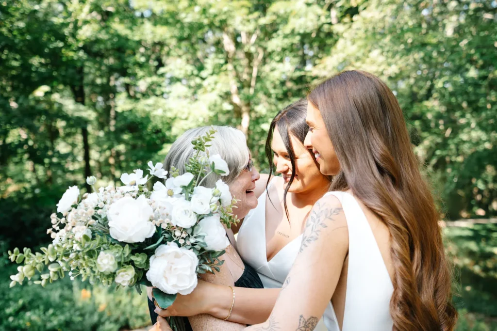 Queer bride sharing an emotional moment with a loved one during her wedding in Hot Springs, Arkansas.