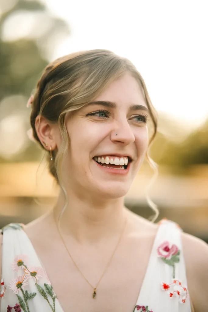 Darcy smiling during her queer elopement at the Dallas Arboretum in Dallas, Texas.