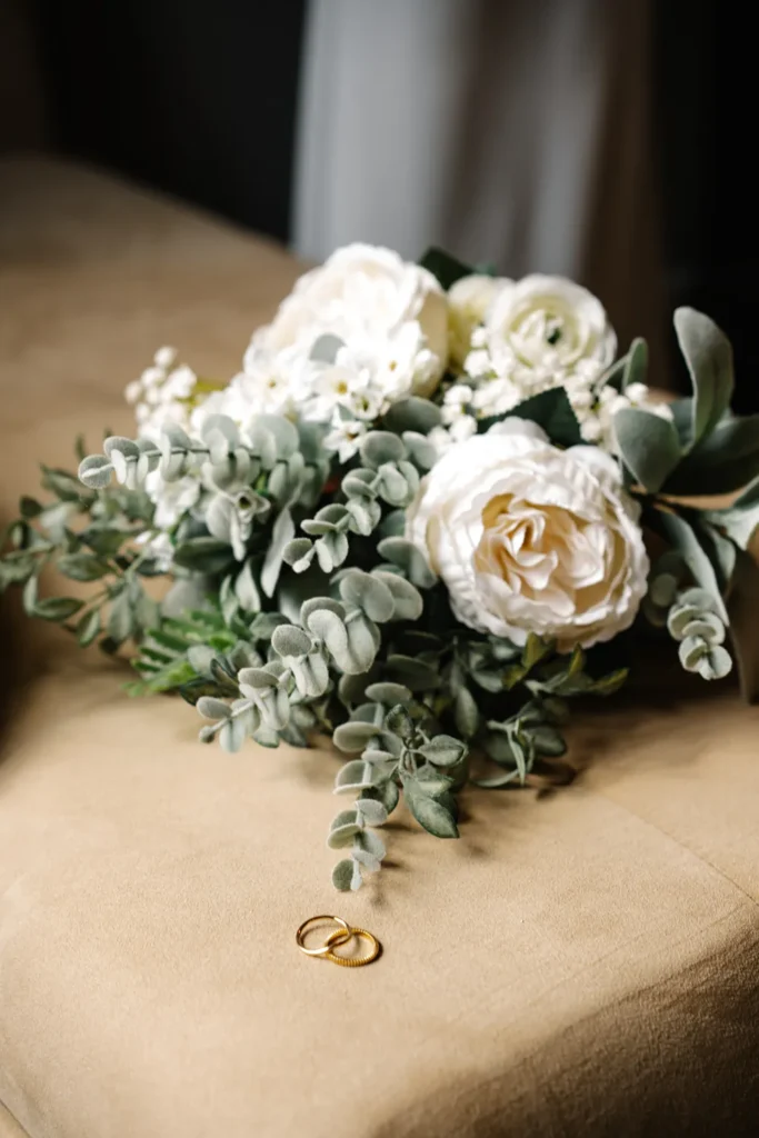 Close-up of wedding bouquet and rings from a queer wedding getting ready moment in Hot Springs, Arkansas.