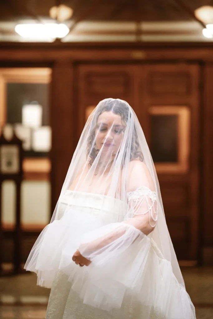 Bride wearing a veil during her queer LGBTQ elopement inside the Fort Worth courthouse.